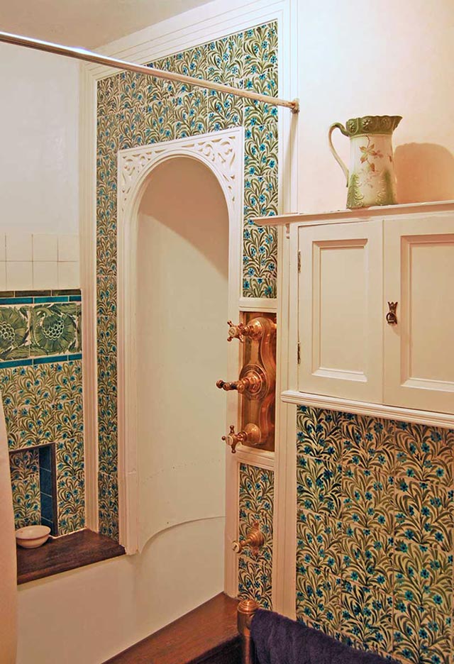 Shower and bath with wall to ceiling De Morgan tudor rose tile